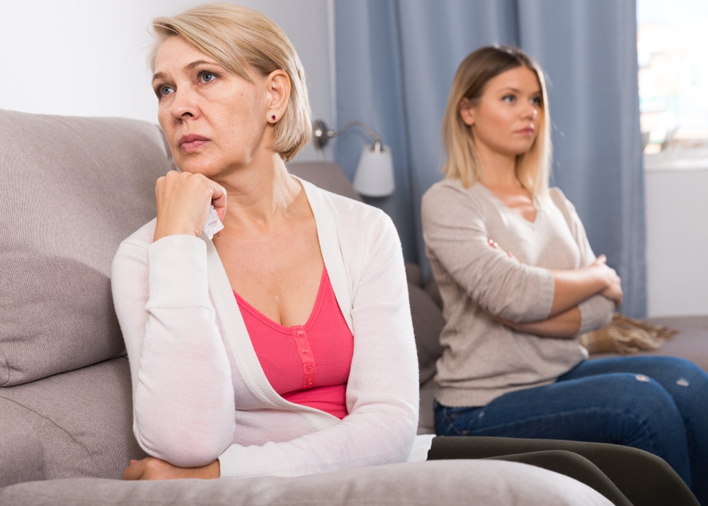 Mother and daughter ignoring each other.