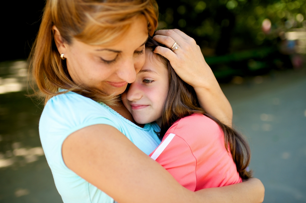 Mother soothing her daughter.